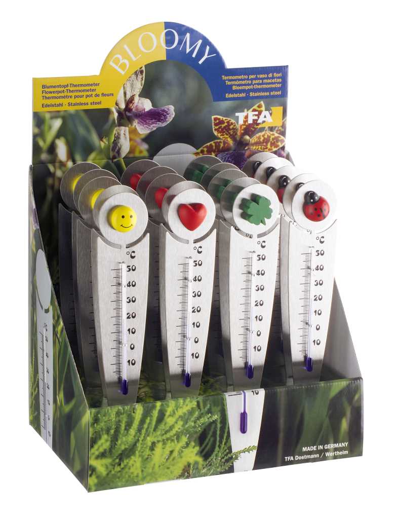 Thekendisplay mit mehreren Metallthermometern, oben runde Motive in Smiley-, Herz-, Kleeblatt- und Marienkäferform